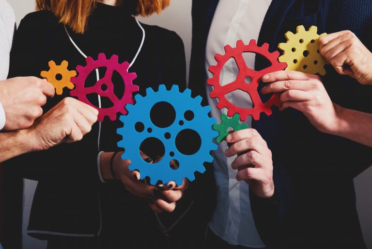 People holding colored gears to show how free transcriptions work